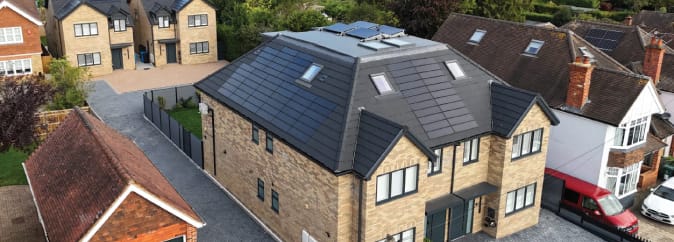 Modern-house-wide-angle-SolarTyle-full-roof SolarTyle integrated solar roof tiles on a modern home, showcasing the seamless design and anthracite colour.
