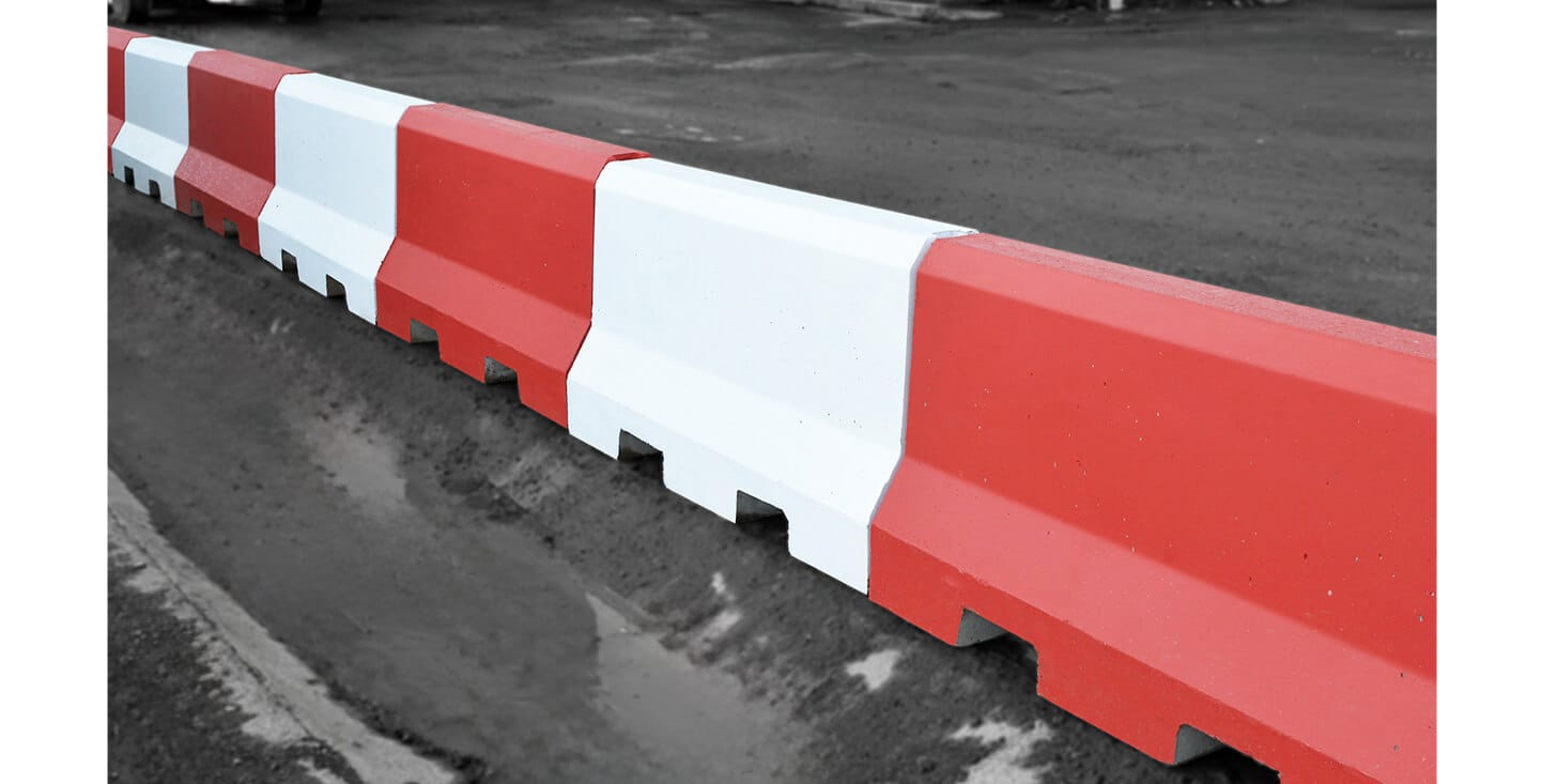 Red and white precast concrete traffic management barriers