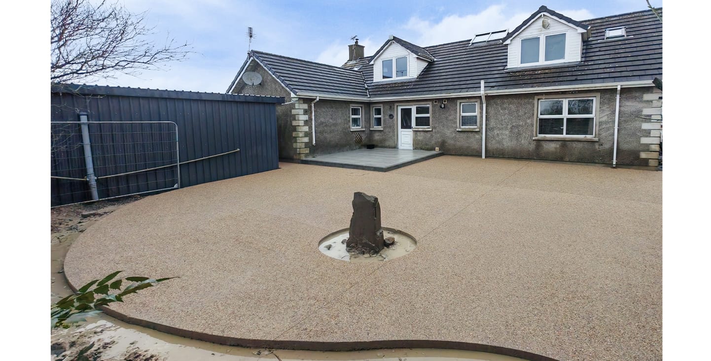Decorative concrete garden with exposed aggregate and stamped patio areas