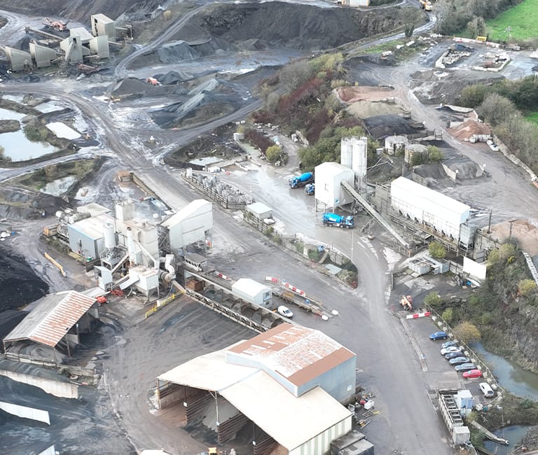 fp-mccann-mallusk-depot-newtownabbey Aerial view of FP McCann Mallusk Depot with ready mix concrete trucks and building material stock in Newtownabbey, County Antrim