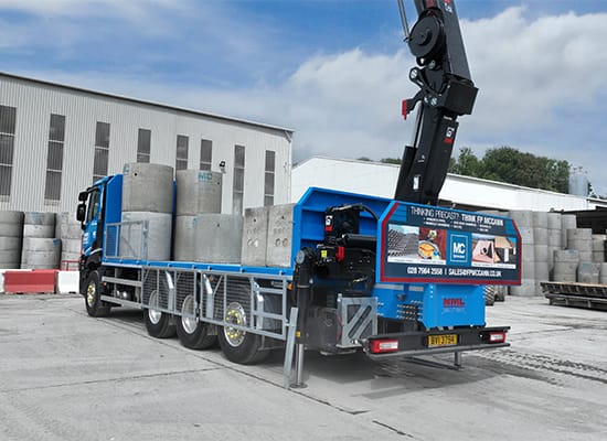 HIAB lorry loading precast concrete pipes for delivery from Knockloughrim
