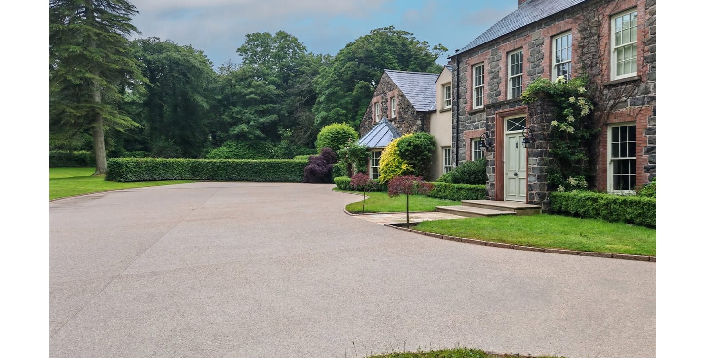 FP McCann Exposed concrete paving installed at a modern residential property in Cullybackey, creating a clean and contemporary outdoor space.