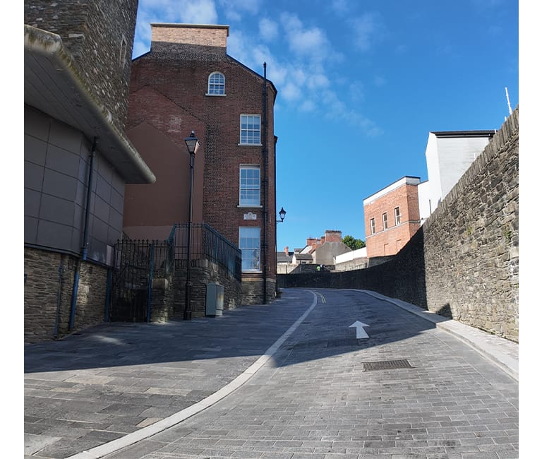 Public realm works around Derry City Walls showcasing high-quality paving, landscaping and enhanced pedestrian spaces.